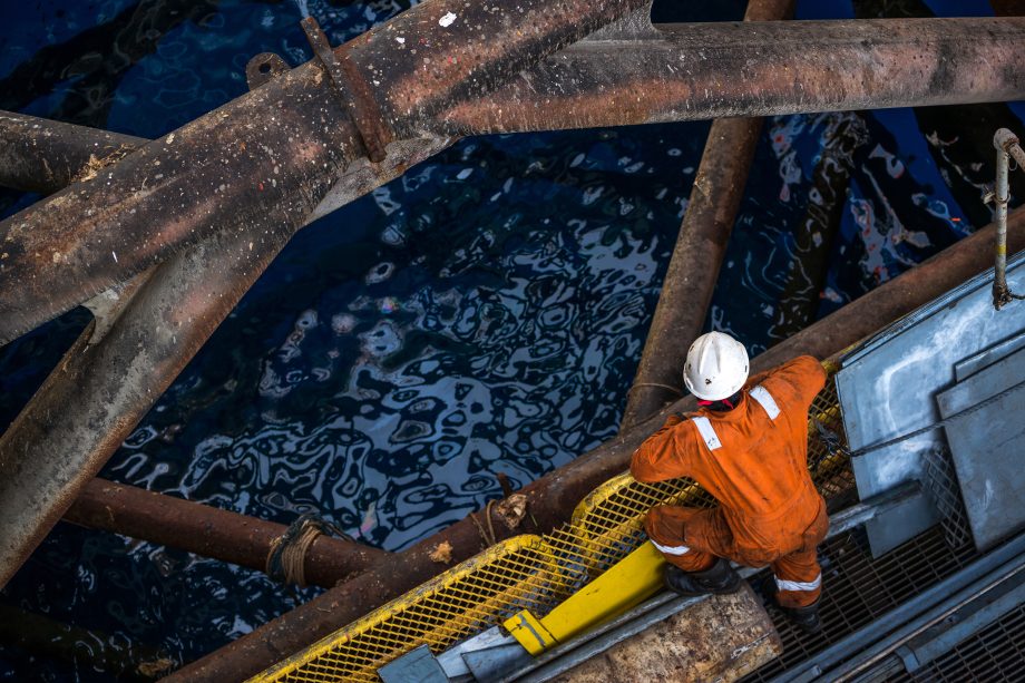 Wokers at jack up oil rig leg when checking everything in rig move operation